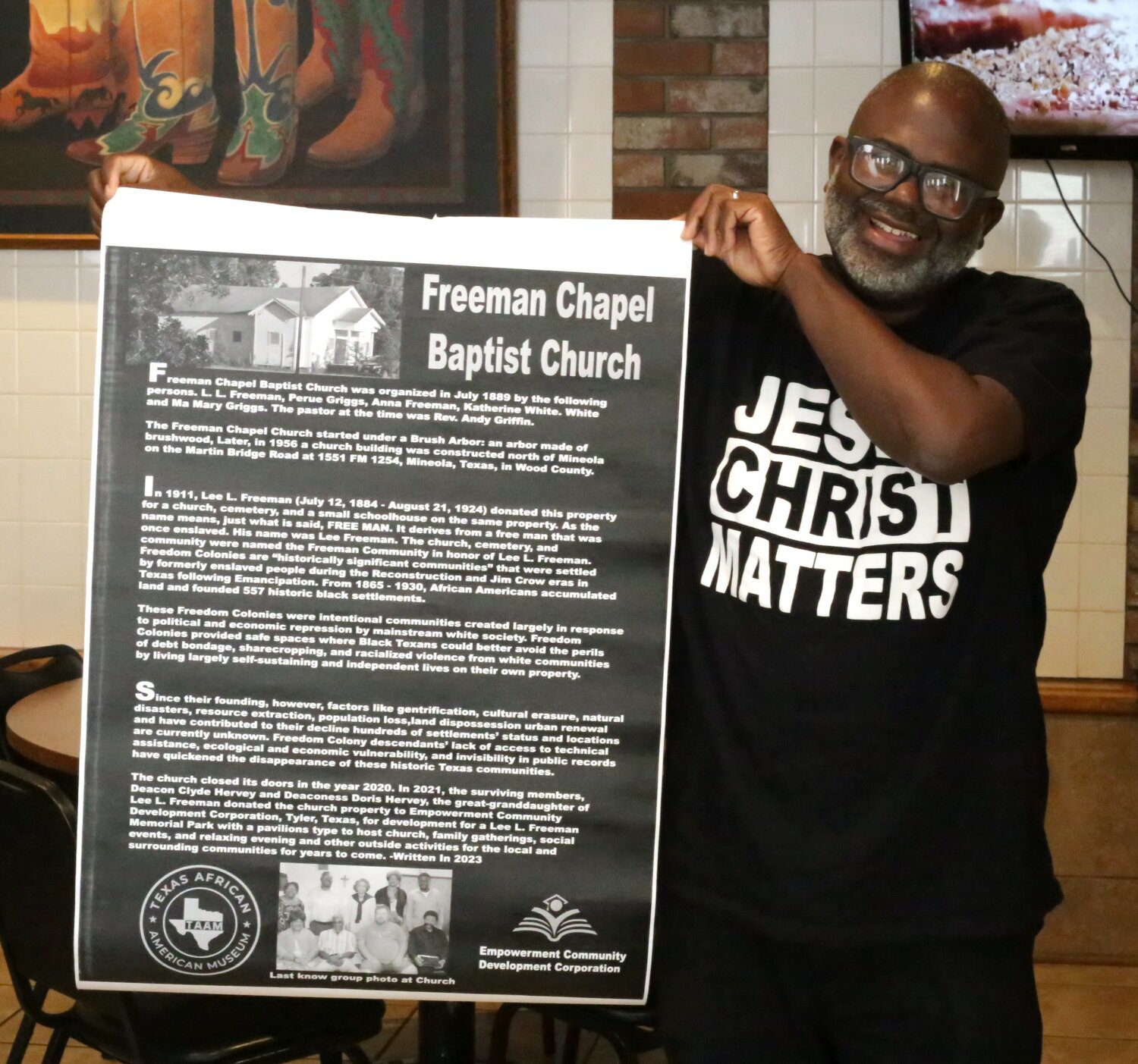 Stanley Cofer displays a paper copy of the proposed locally-produced historical marker which is planned to be installed at the site of the Freeman Chapel on Saturday,  July 8.