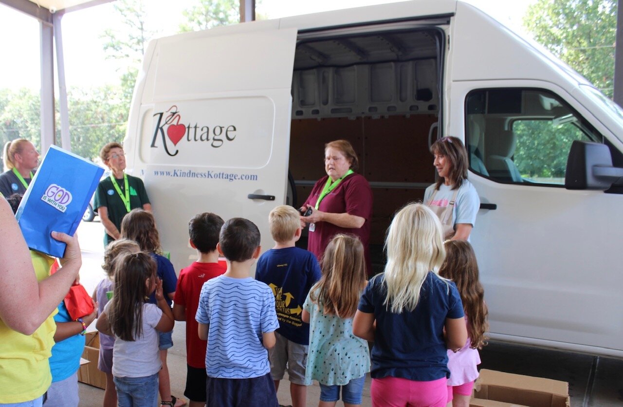 From left, Judy LeFlore, mission teacher; Debbie Quadracci, speaker; and B.J. Gold, Kindness Kottage executive director, speak with children at Holly Brook Baptist Vacation Bible School.