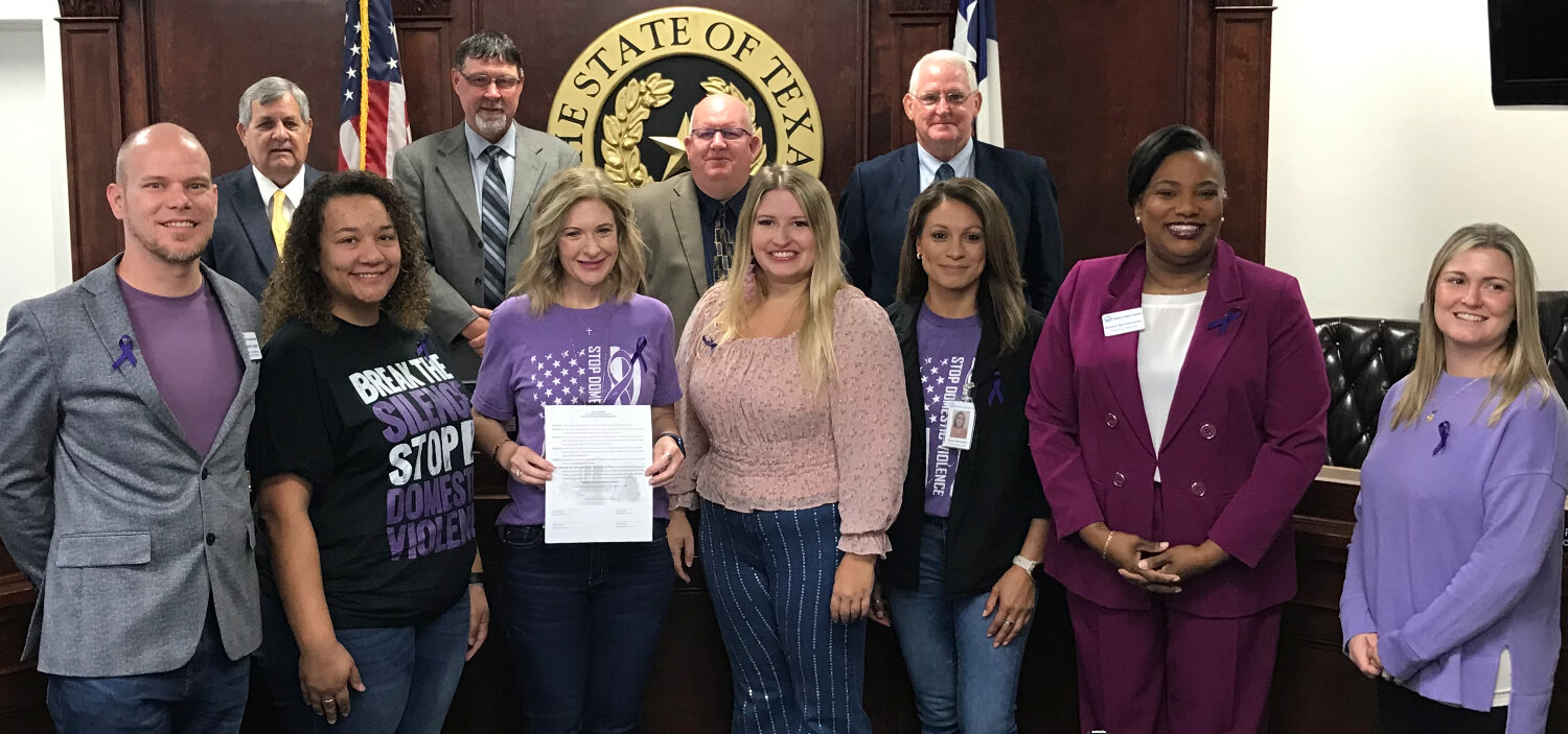 On hand for the proclamation declaring October as Domestic Violence Awareness month in Wood County were, from left, front row, Jeremy Flowers, Kristi Hunter, Angela Albers, Kayla Glidewell, Maira Hernandez, Nicole Masters-Henry and Cheryl Collins, with (back) Commissioners Virgil Holland, Jerry Gaskill, County Judge Kevin White and Commissioner Mike Simmons.
