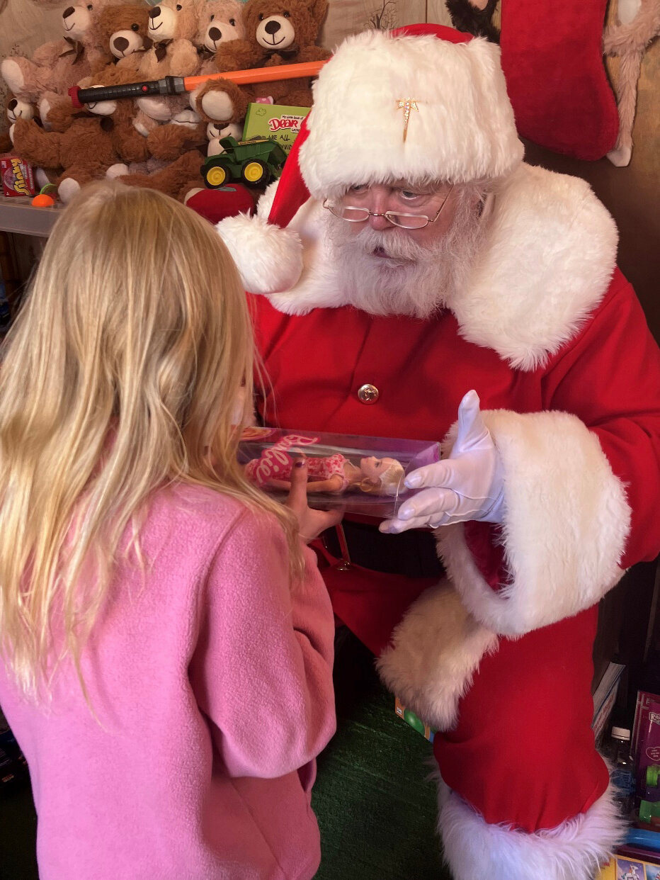 Santa made an appearance in his Little Red House, which is behind the Mineola Historical Museum, this weekend. Santa has come bearing toys and smiles to Mineola’s kids for over 30 years. Pictured with Skylar Bennett.