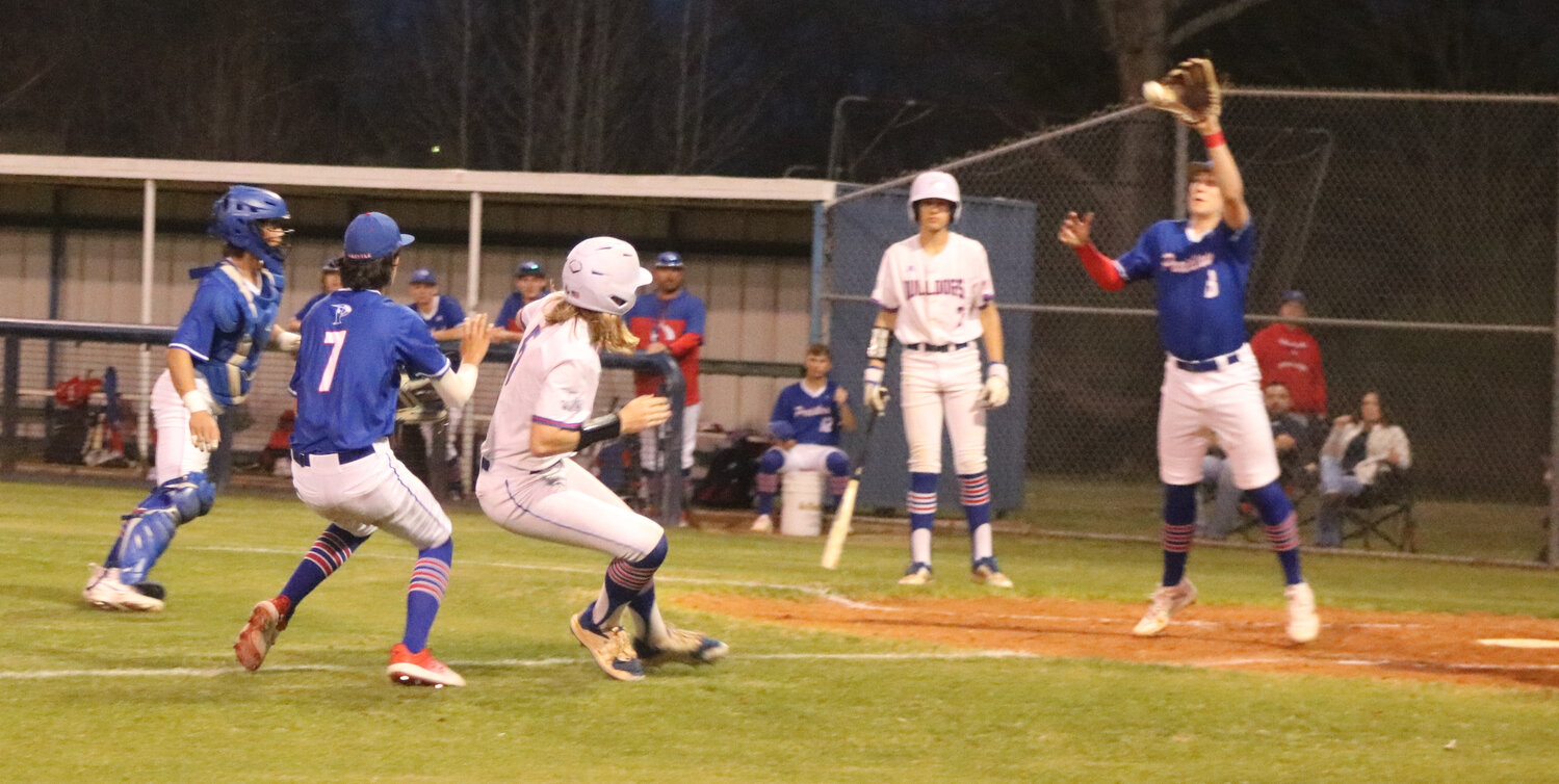 Quitman’s Tommy Drinkwine gets caught in a rundown trying to steal home.