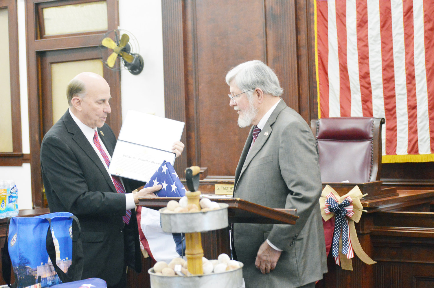 Judge Tim Boswell receives a flag which has flown over the capitol from Congressman Louie Gohmert.