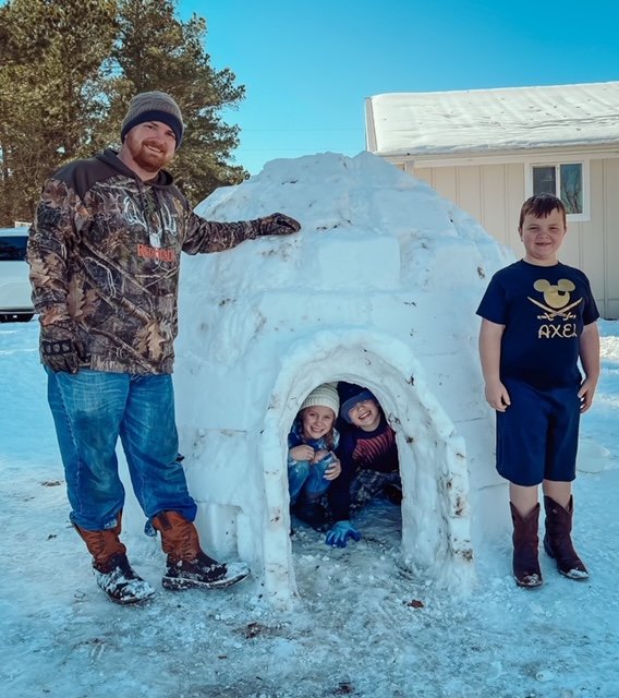 Brandon Roberts and sons Axel (outside) and Camden spent about 10 hours constructing an igloo using 98 blocks.