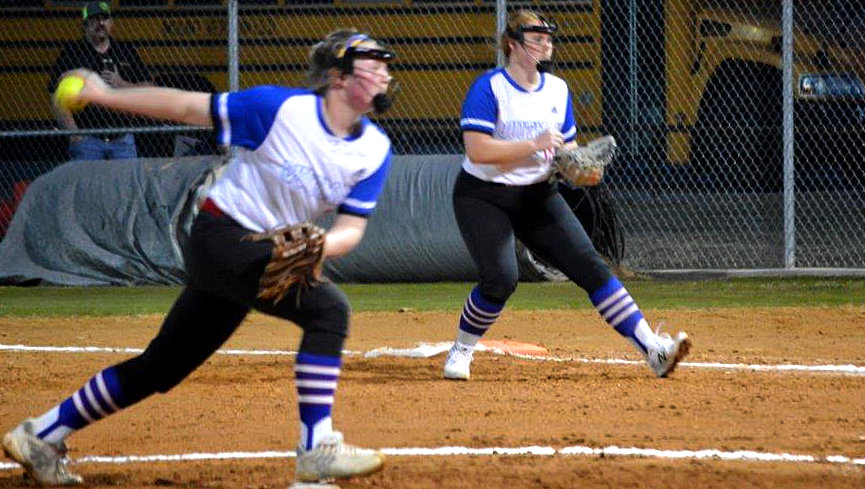 Quitman’s Kennedi Elmore fires a pitch as first baseman Reiny Luman backs her up against Mt. Vernon.