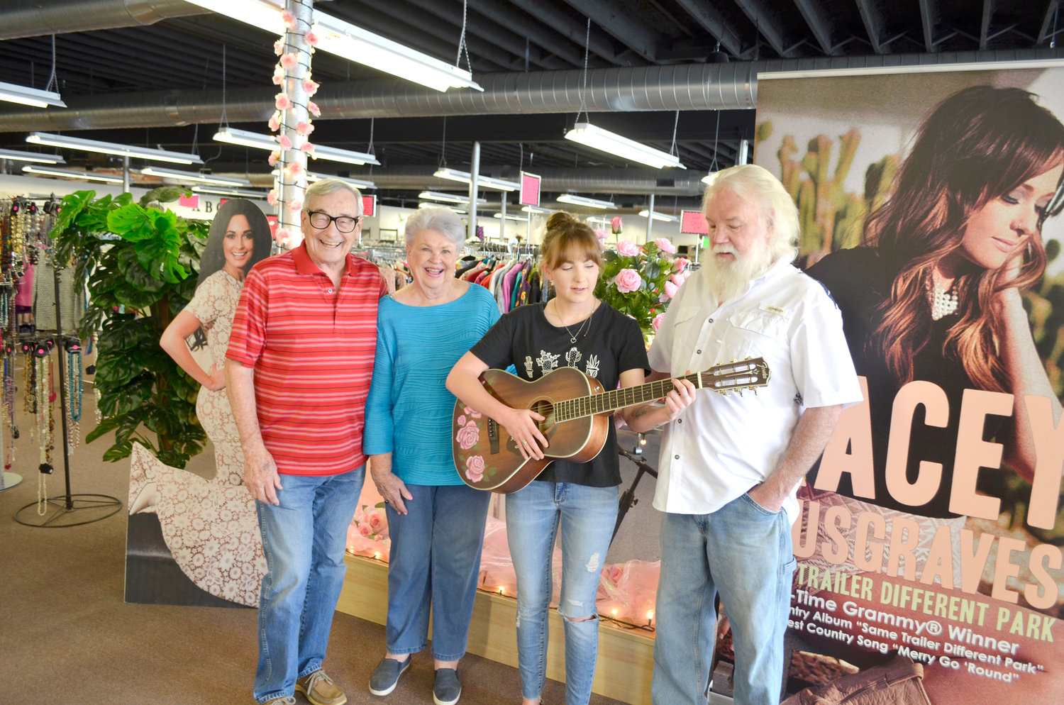 Darrell and Barbara Musgraves, left, congratulate Abby Vann and her father, Darrell Vann, on winning the Kacey Musgraves’ autogrpahed guitar at the Kindness Kottage in Mineola. Darrell bought the winning ticket and gifted the guitar to Abby, an aspiring musician.