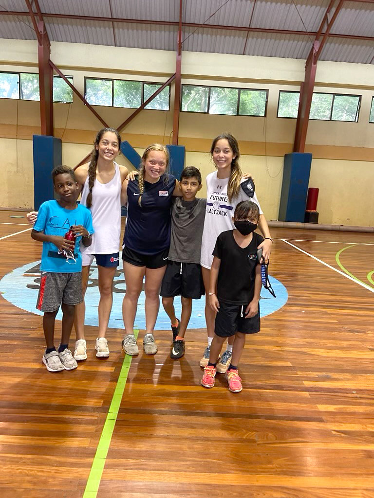 Mineola athletes, from left, Kapri Riley, Riley Weekly and Keilee Riley recently completed the Girls Leadership Academy for Service and Sport in Costa Rica, shown with some of the local children.