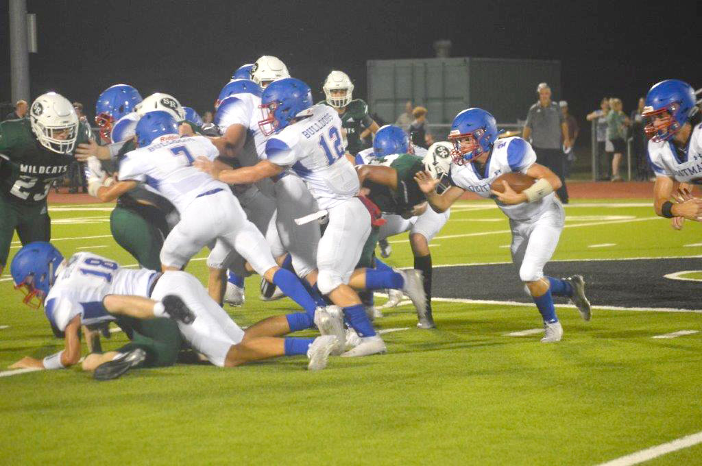 Quitman’s Ford Tannebaum (2) follows the blocking of Ethan Presley (18), Jack Tannebaum (7) and Wyatt Hightower (12) in Friday’s game at Surry-Rosser.