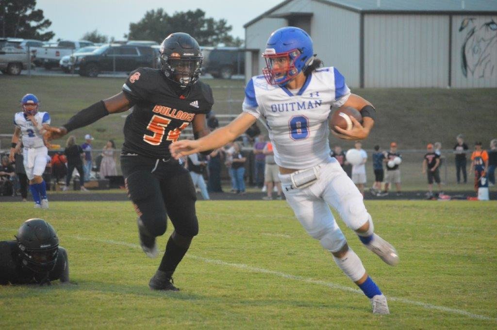 Quitman’s Mason Reynolds (8) gains yardage in the Bulldogs’ 25-20 win at Queen City. Reynolds scored a pair of touchdowns and had over 100 yards rushing.