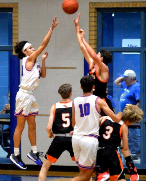 Quitman’s Thomas Sebedra (30) gets off a shot in the Bulldog’s win over Grand Saline as teammate Ethan Presley (10) looks to rebound.