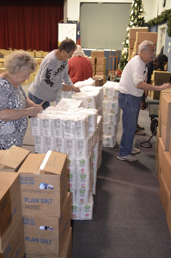 Volunteers prepare for the big distribution day for Caring and Sharing of Mineola, including Ed Castro and Art Gould.