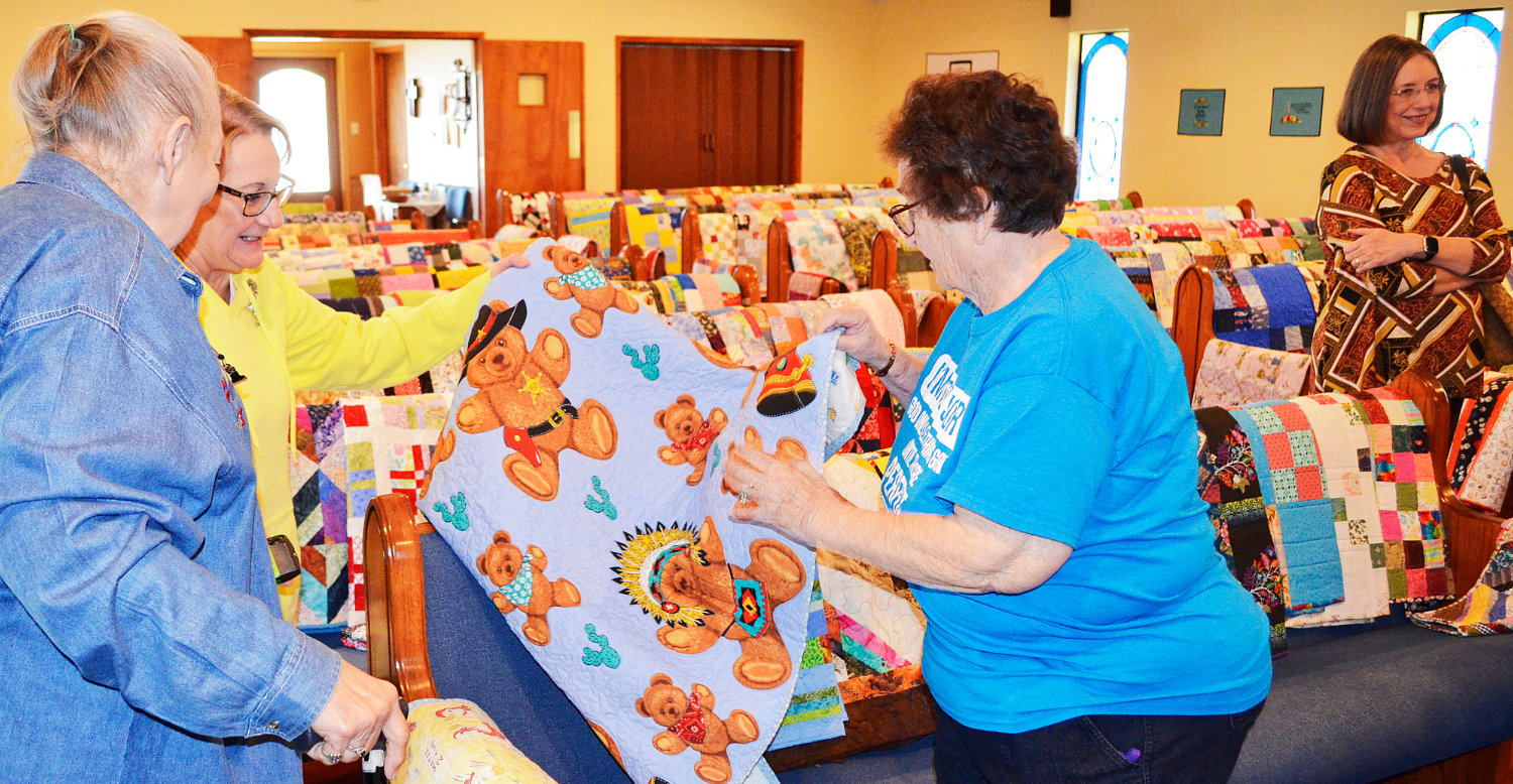 Colorful quilts line the sanctuary of the Alba United Methodist Church where they were blessed and then packed up to stock the Rainbow Rooms of East Texas where they will go to children who have been removed from their homes by Child Protective Services.